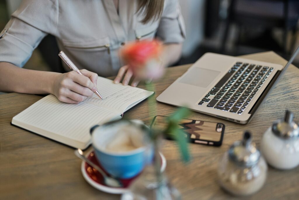 Person calmly planning at desk with coffee - stress-free New Year resolution to make a Will